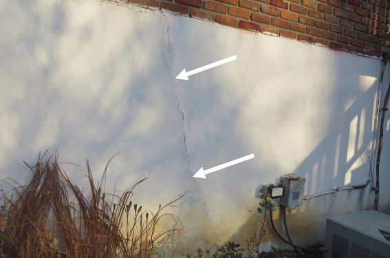 Backfilled garage wall showing cracks